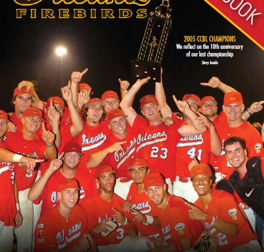 Cover of the 2015 Orleans Firebirds yearbook showing the 2005 Orleans Cardinals celebrating the Cape League title with the trophy