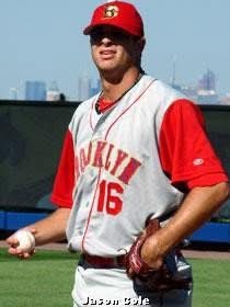 Brant in a Brooklyn Cyclones road uniform, number 16, holding a baseball
