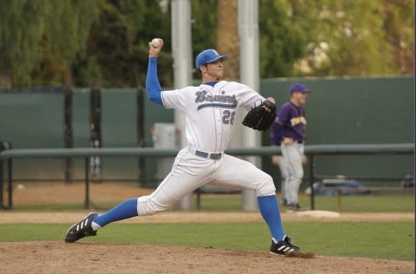 Brant pitching for UCLA in a white Bruins uniform, number 28