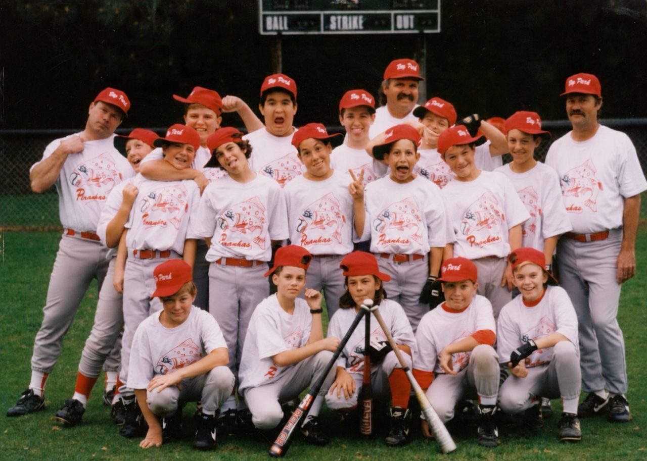 The original Bay Park Piranhas team hamming it up for the camera on Tecolote Bronco Field, scoreboard behind them